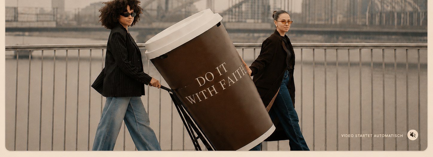 Two women pulling a giant COF coffee cup across a bridge in Cologne