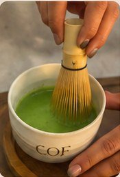 Matcha being whisked in a COF bowl