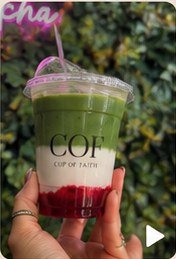 A COF matcha drink held up outdoors