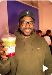 A guest holding a COF drink at an event
